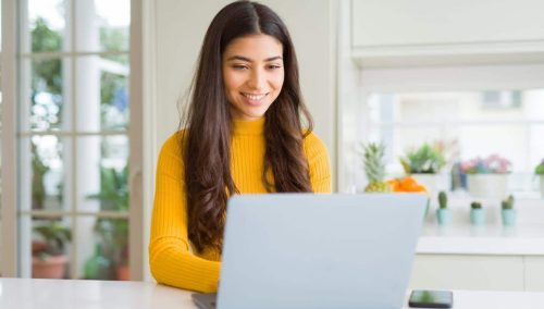 girl smiling at the computer happy with website management